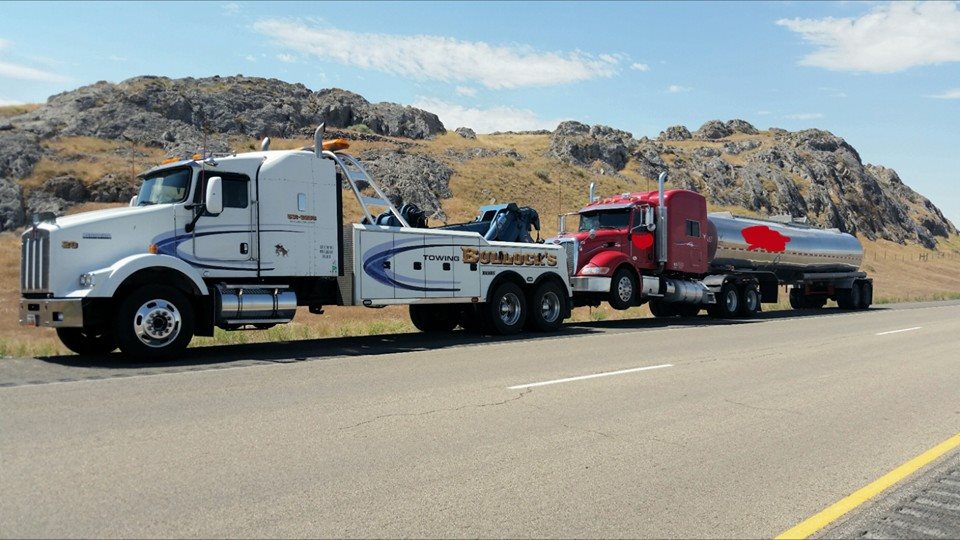 towing services slider image of red truck being towed