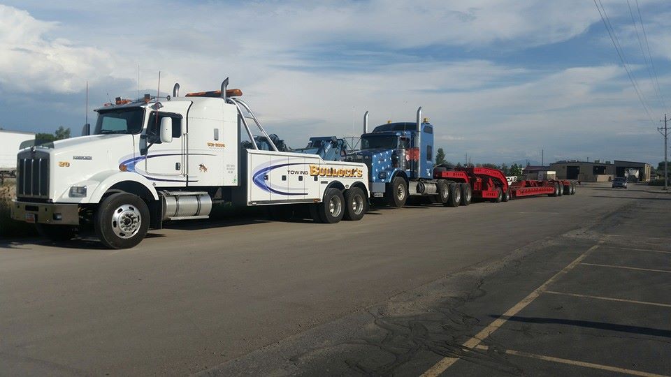 blue semi truck with white stars being towed