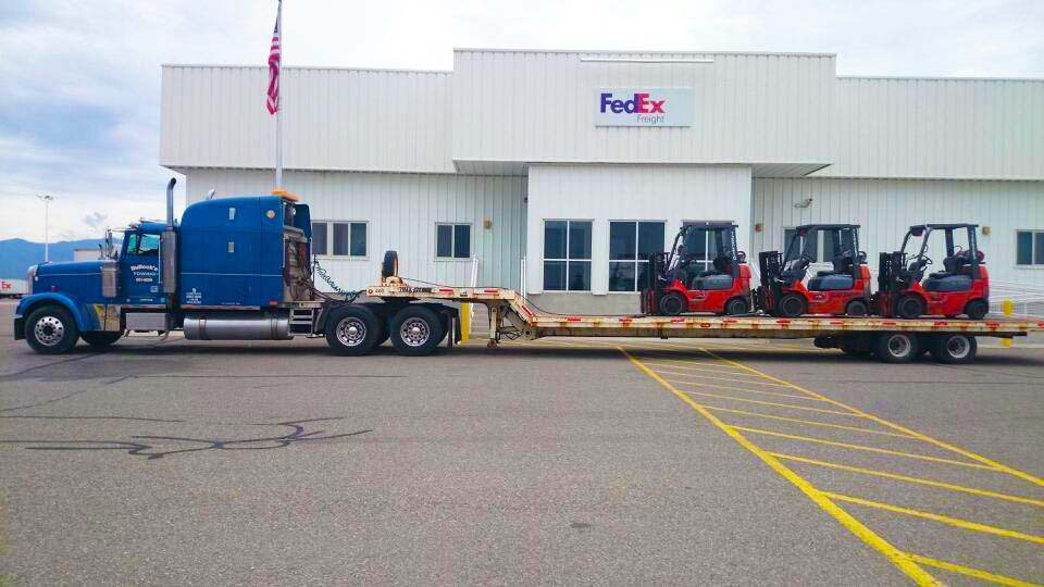 bullocks towing three forklifts on trailer