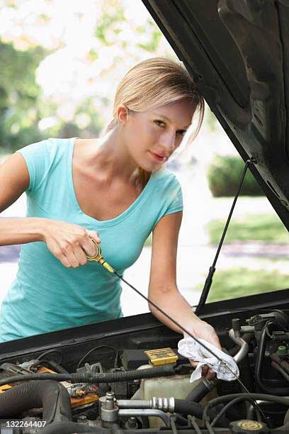 diy car care woman changing oil image